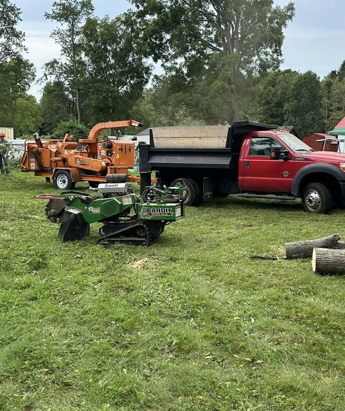 1776 Tree Service chipper, stump grinder and dump truck on a job